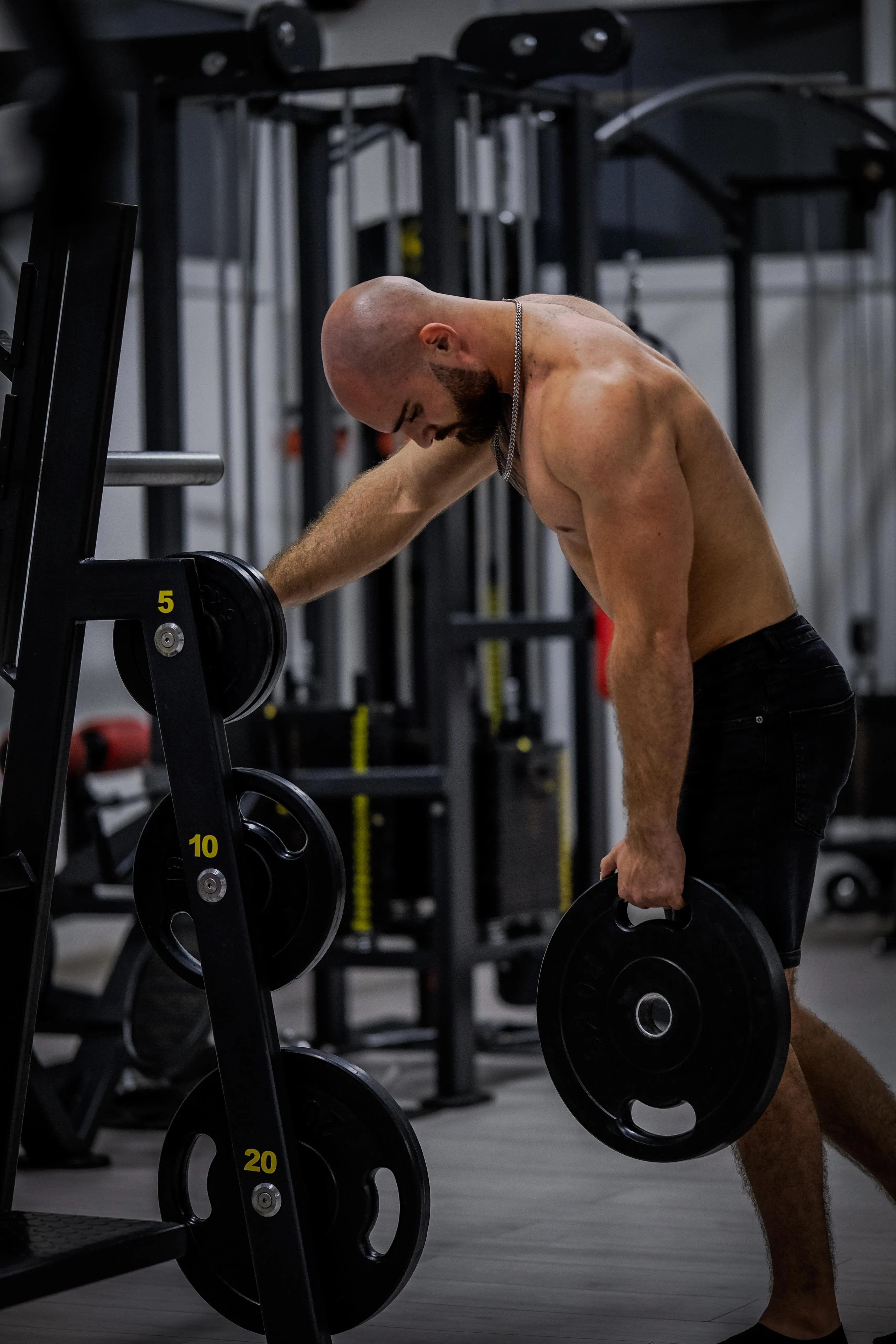 Man doing shrugs with weight.