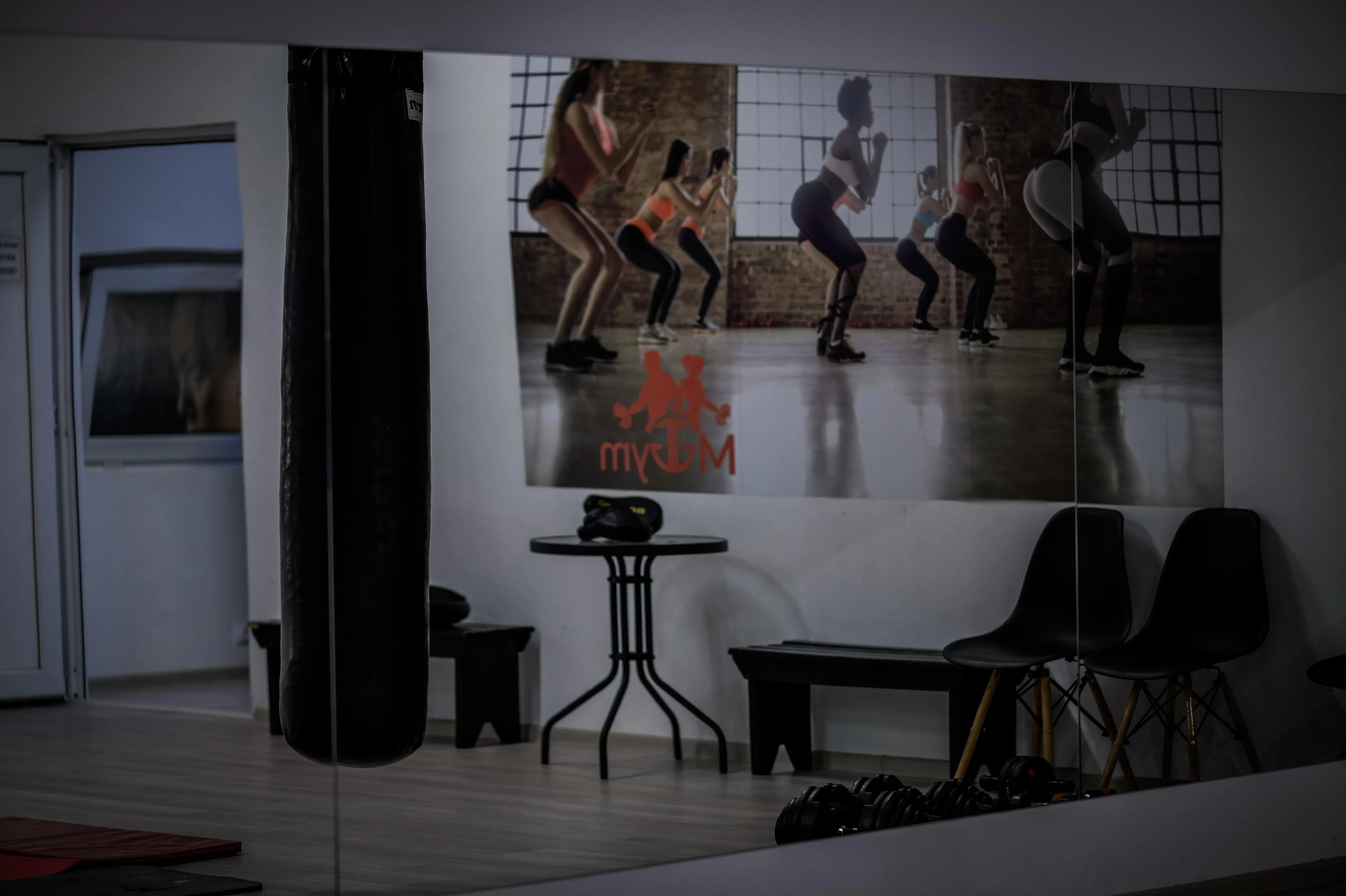 Gym location with heavy bag and yoga balls.