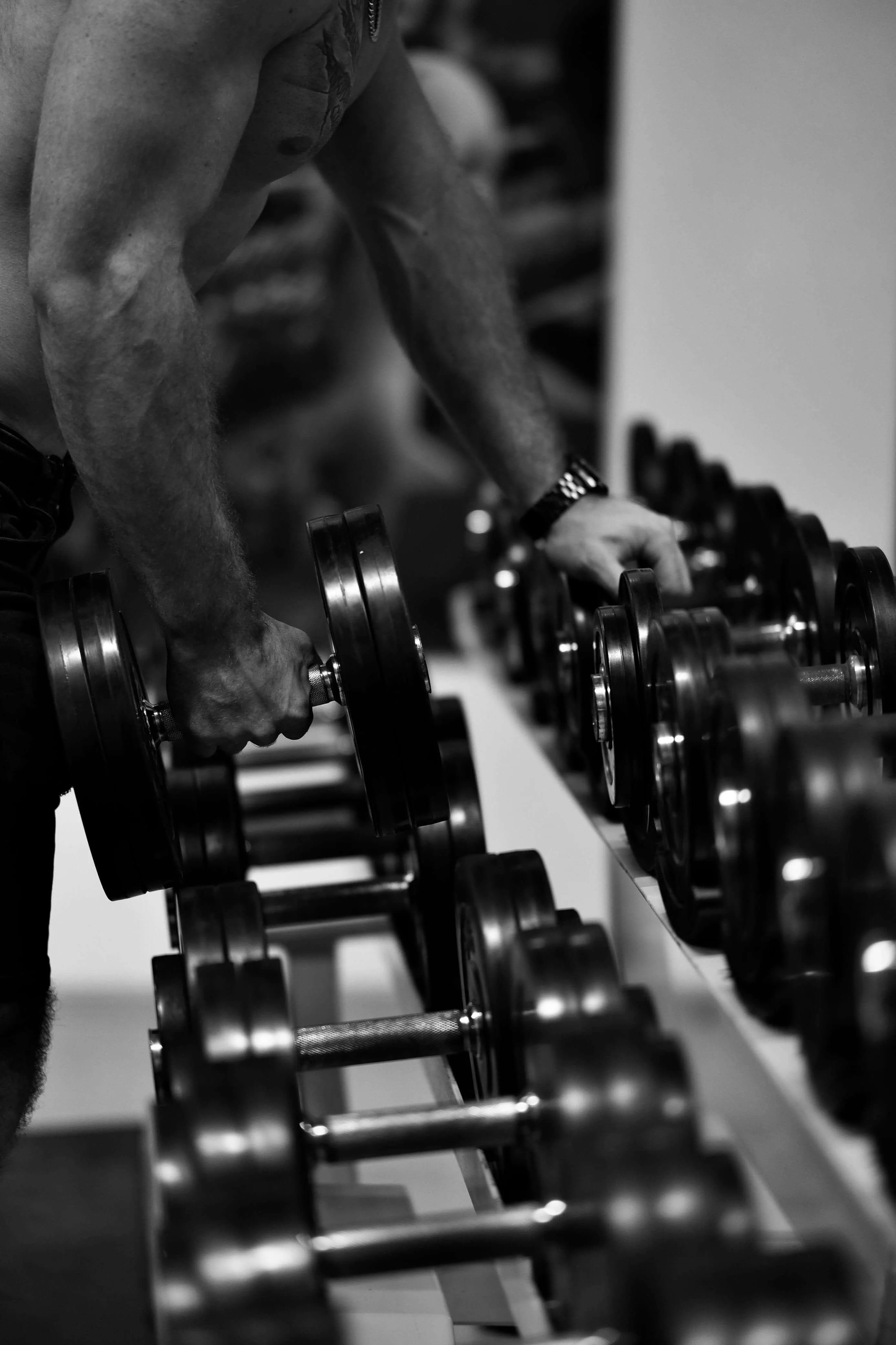 man holding a dumbell and working out